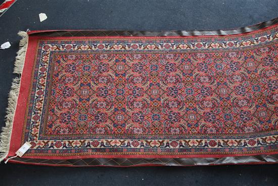 A Persian runner, 20ft 10in. x 2ft 6in.